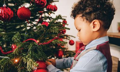 Adorable 3 Year Old Toddler Boy Decorating Christmas Tree