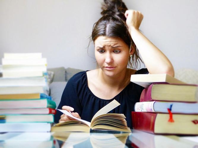 Woman studies a complicated medical textbook