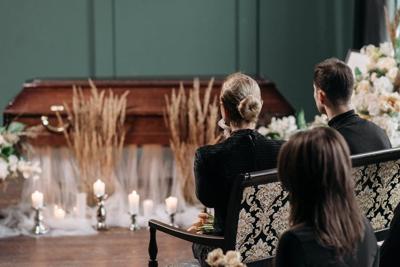 People sit in rows at a person's funeral