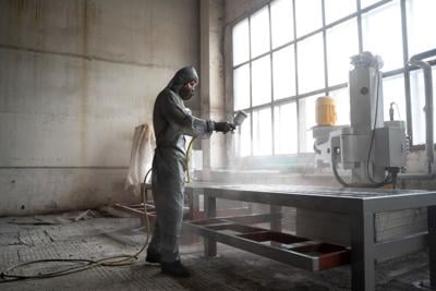 Man uses a professional spray machine