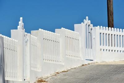 A white fence being Installed to Secure the Home