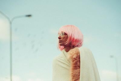 Woman wears a colorful pink wig as a form of stylish self expression