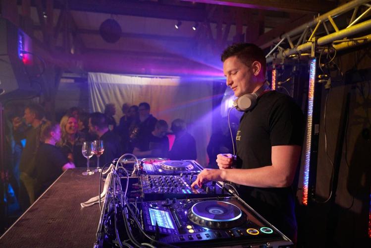 DJ plays music at a person's high-end event at their home