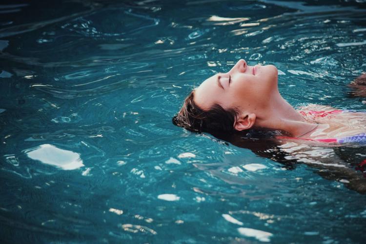 Woman floats in water during her frequent swims