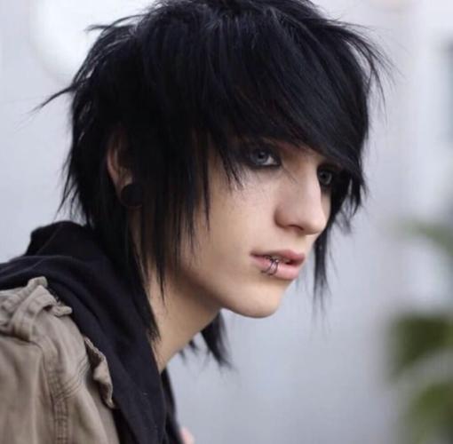 An emo person wears their hair in a sideswept hairstyle, covering one eye