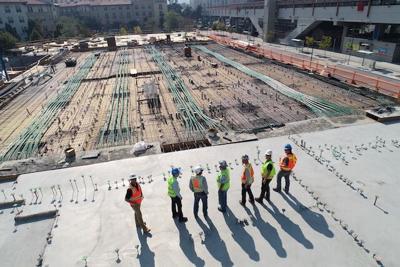 Men line up at construction site where their health and safety concerns are taken care of