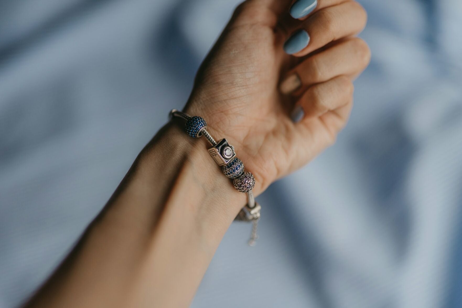 Person wears beautiful silver beaded bracelet on their wrist