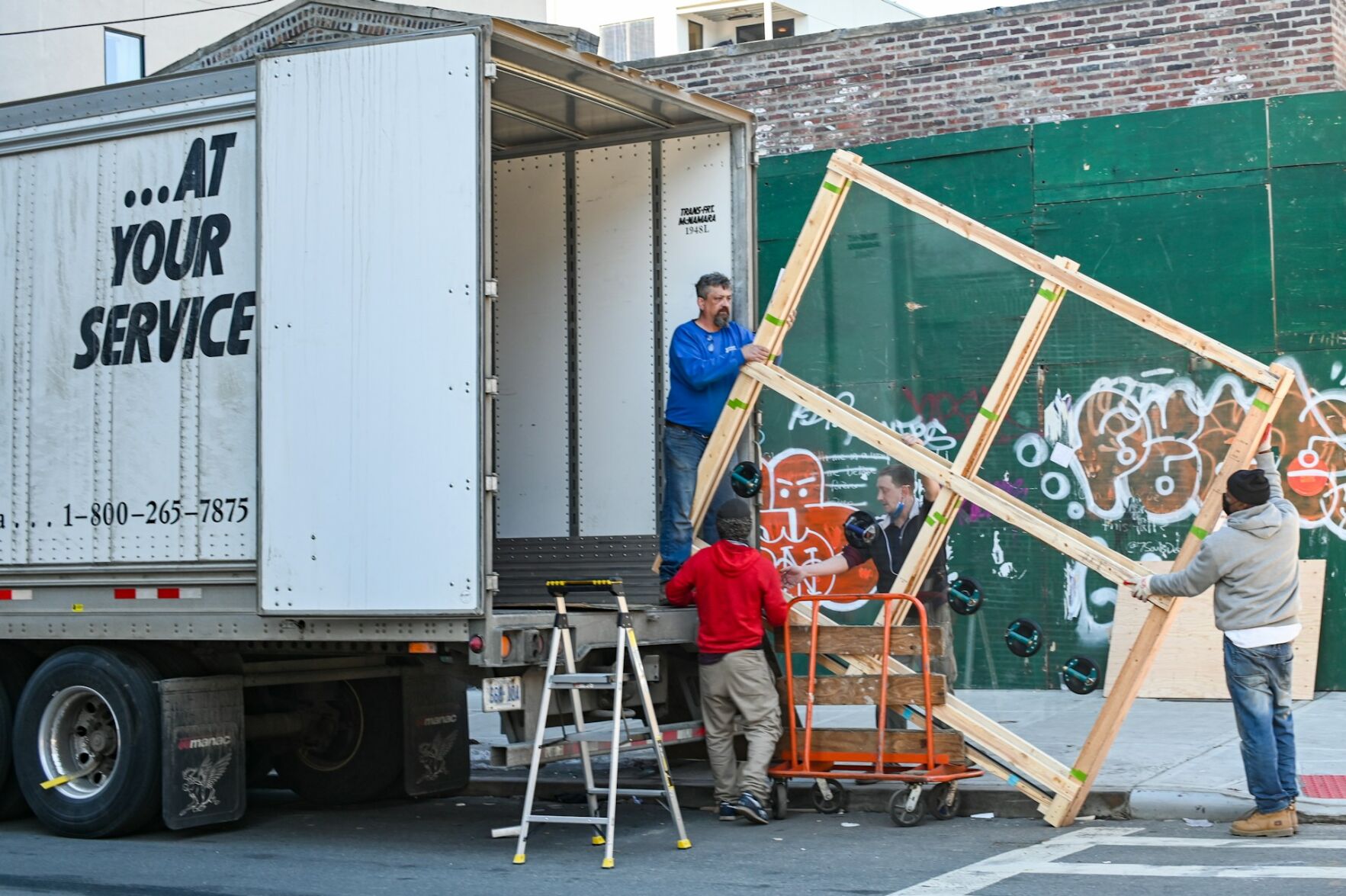 Men load moving van with belongings to support a person's move in Miami