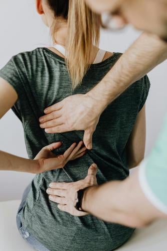 Woman sees a chiropractor to manage back pain