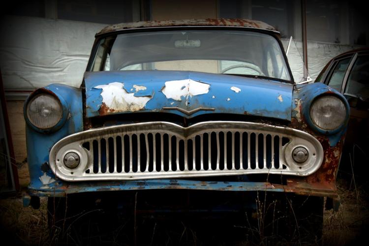 Broken down junk car waits around for proper disposal
