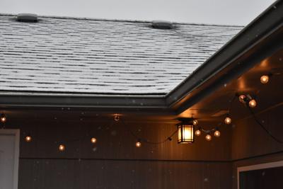 Outdoor lighting, like seen on this roofline, can increase the curb appeal and safety of a home