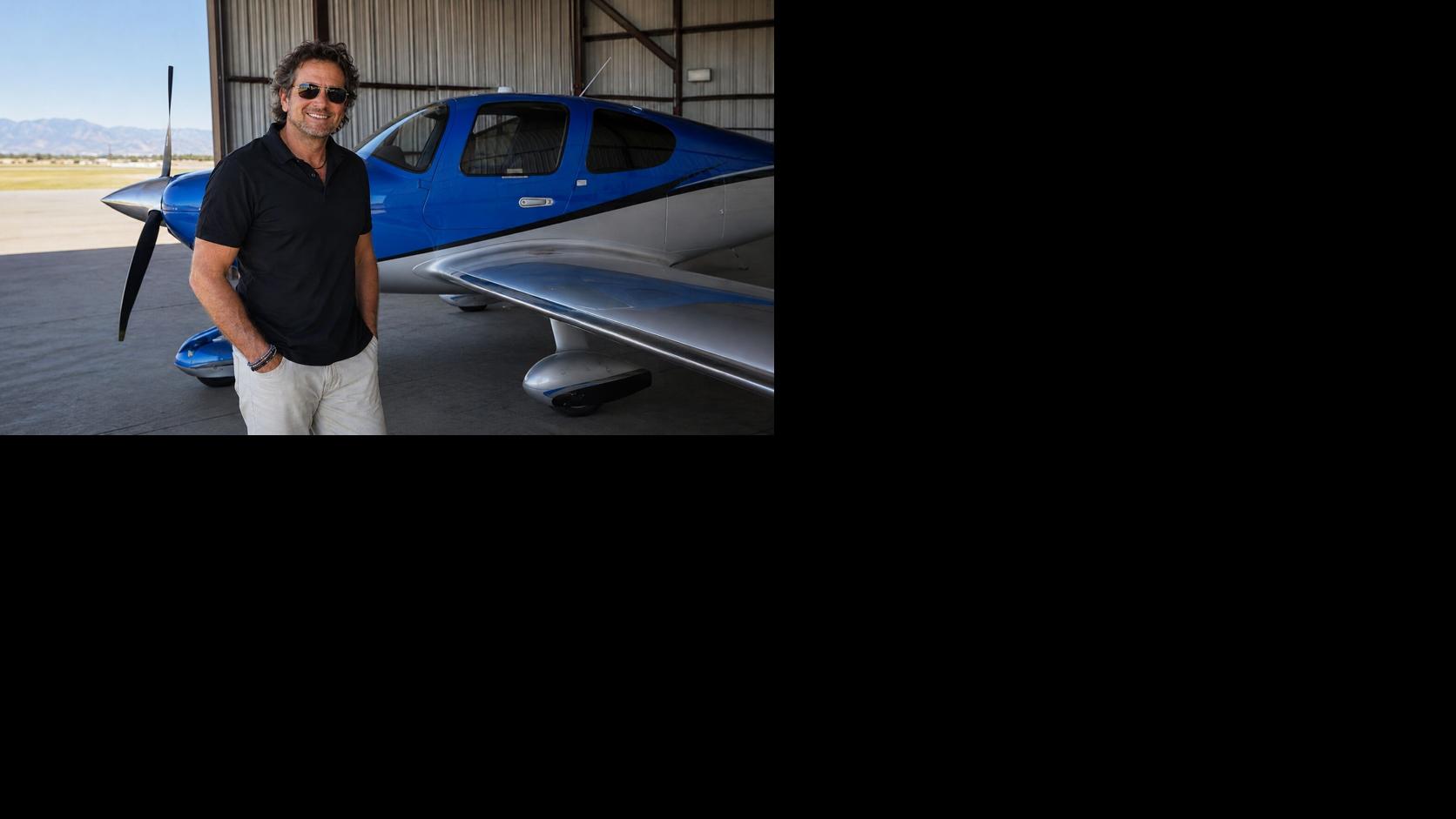 David Lieber standing beside a blue-and-silver single-engine aircraft before a flying experience in Southern California.