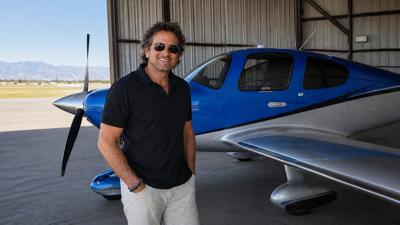 David Lieber standing beside a blue-and-silver single-engine aircraft before a flying experience in Southern California.