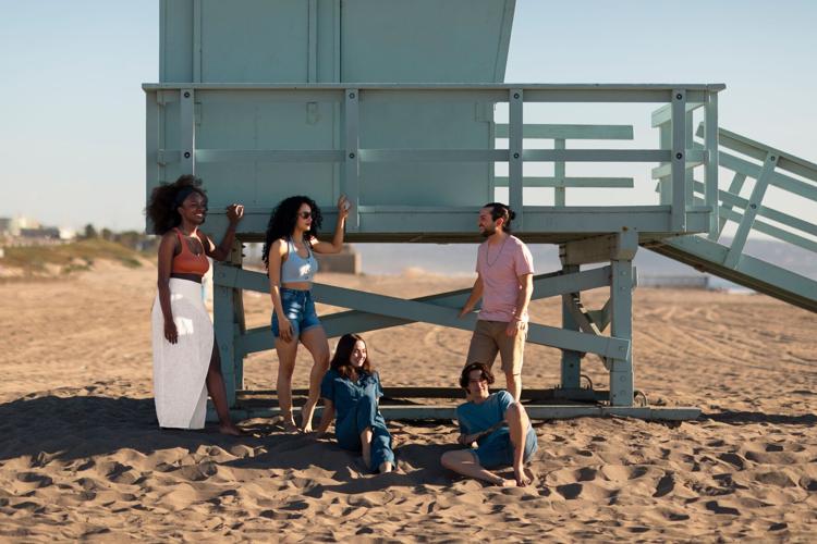 Friends standing in sand 