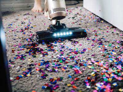 Vacuum sucks up debris on floor, supporting indoor air quality