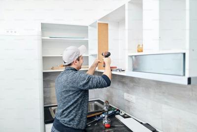 Person comprehensively repairs a cupboard in an Atlanta home