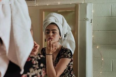 a young woman using her skincare gift set