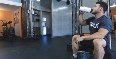 Man at gym drinks protein powder