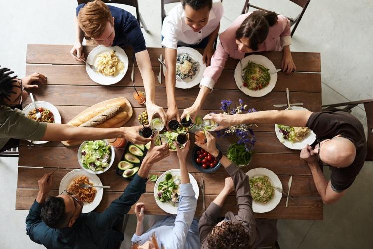 Friends gathered around a table at a perfect dinner event