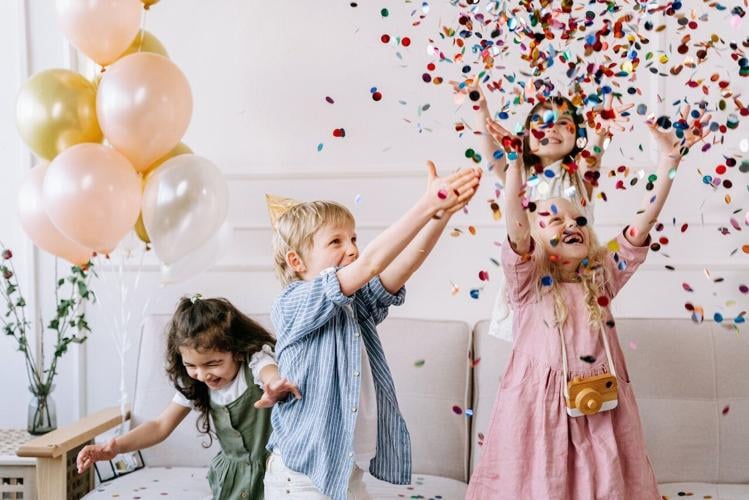 Children playing with glitter at their birthday party