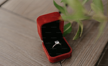 A beautiful diamond sits on a ring in a box