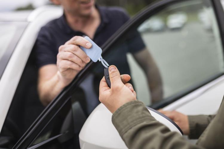 Man receives keys to car financed with a loan