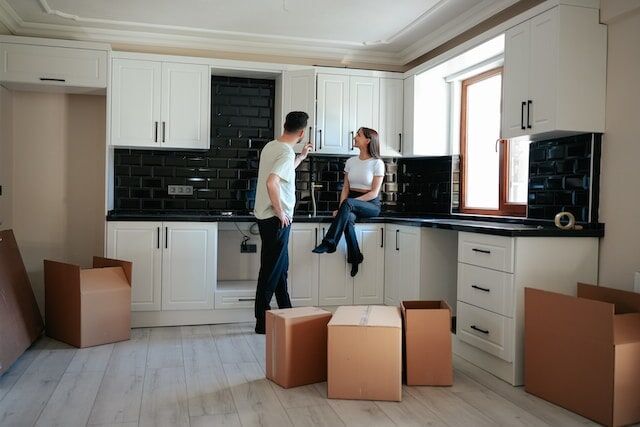 Couple unpacks moving boxes into efficient home storage designs