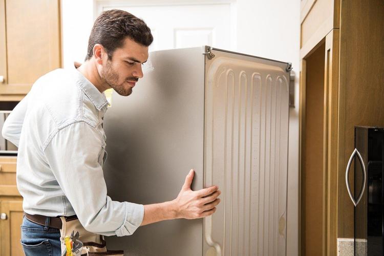 Man moves his fridge during home move-in process