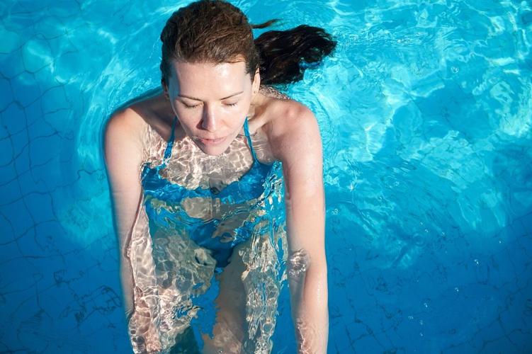 A woman swims in a pool for a great day of exercise