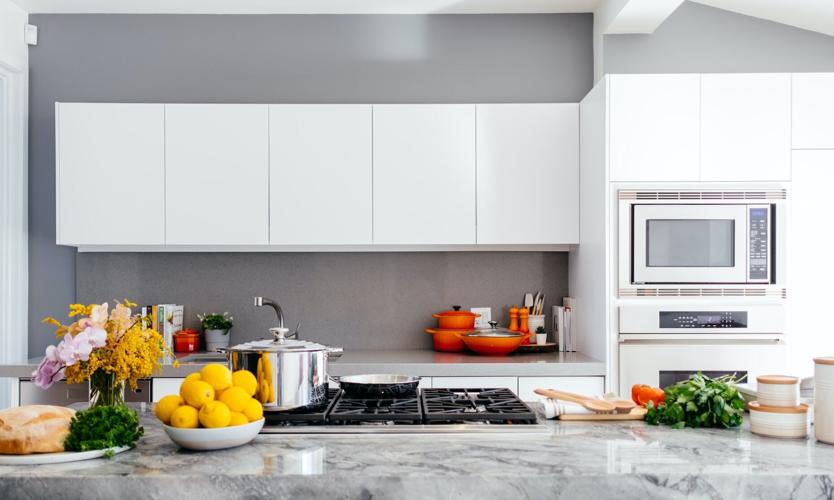 Kitchen island with renovated cabinets and granite countertops