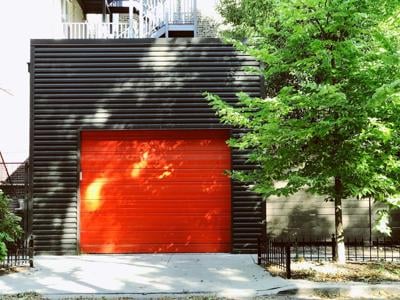 Red garage door completes the exterior design of this house