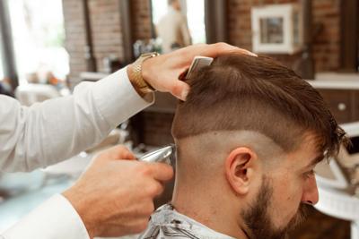 Man gets drop fade haircut at barbershop
