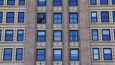 Commercial building with window cleaner cleaning the windows