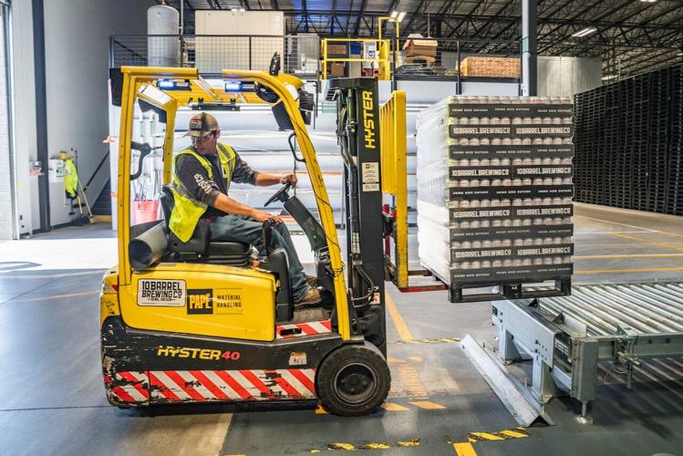 Man operates forklift in a storage warehouse