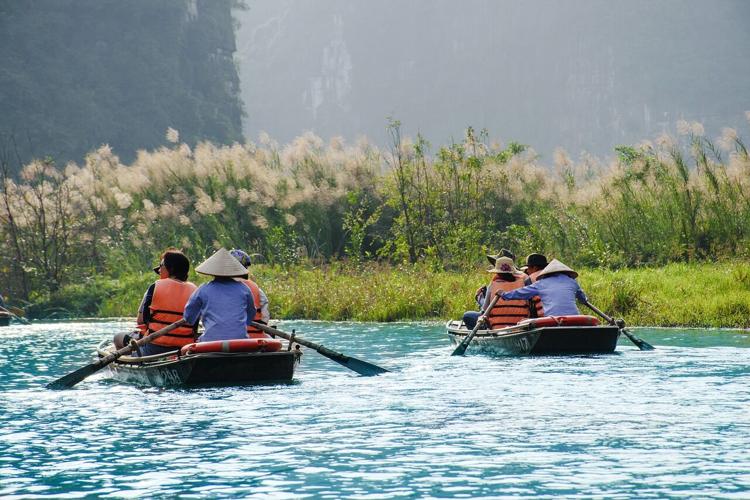 People float down a river on a transformative travel adventure
