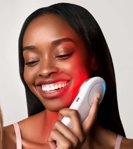 A beautiful colored woman using The Tri-Light™ with the +SABI AI app