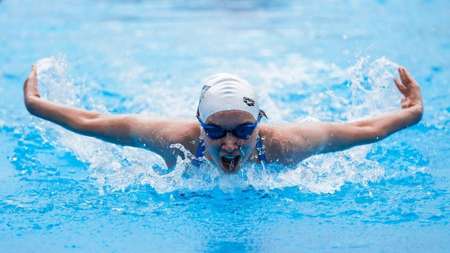 Person does butterfly stroke in pool