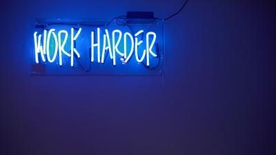 Neon signs, like this one that says "work harder", can be an aesthetic design choice