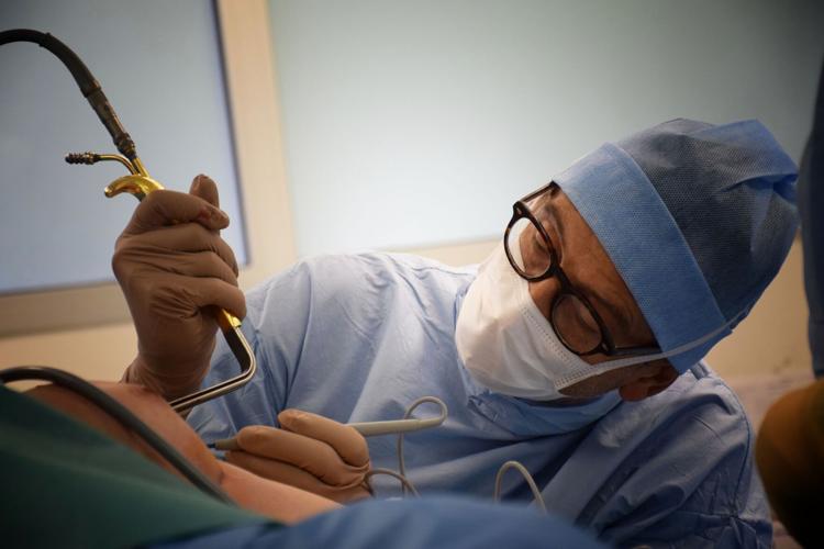 Surgeon conducts plastic surgery procedure that can improve social well-being