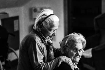 Two elderly women interact at retirement community