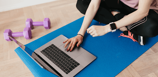 A woman learning How to Use Youtube for Marketing your Fitness Studio