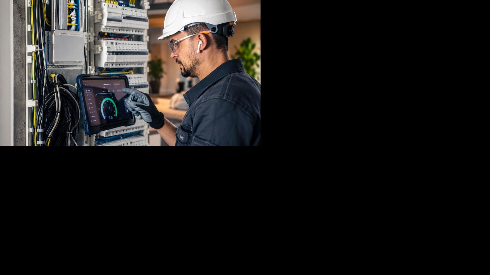 Electrician inspecting a circuit breaker panel in a home electrical system