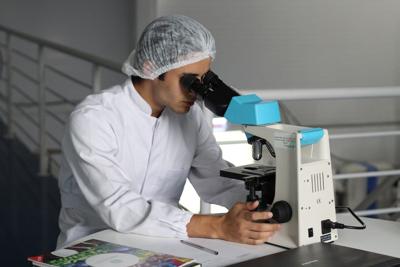 Biotechnology scientist uses microscope to study innovative new technologies