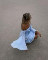 A woman on the beach wearing Tiare Hawaii's Tropical Fashion