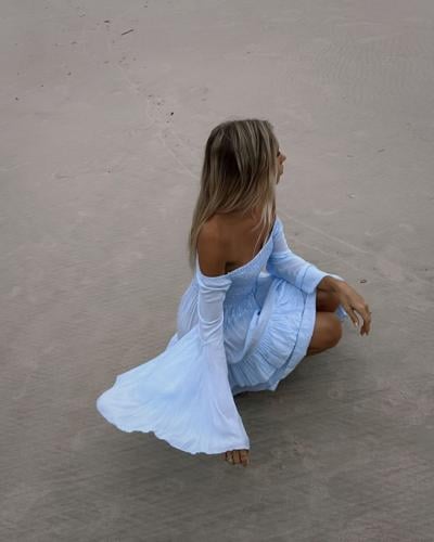 A woman on the beach wearing Tiare Hawaii's Tropical Fashion