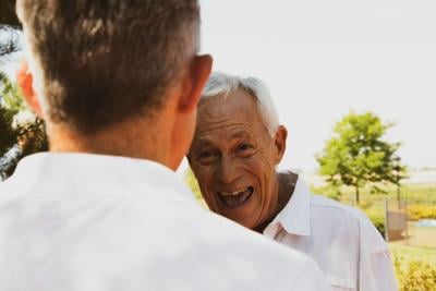 Elderly man grins at his friend
