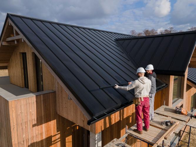 Roofers from a roofing company fix a home's roof