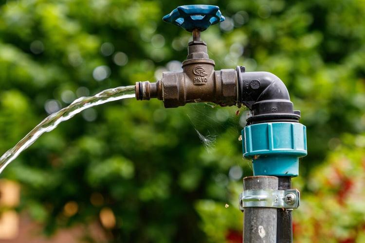 A spout spews water as a result of water theft