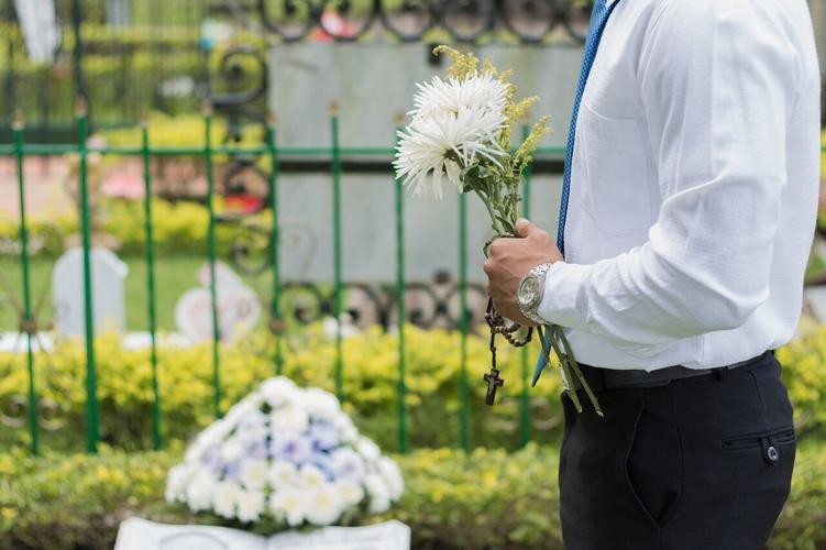Man brings flowers to funeral at funeral home