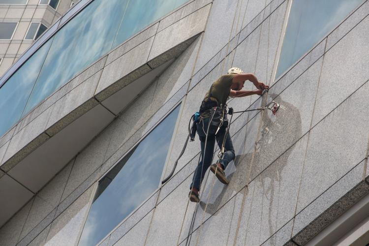 Window cleaner climbs building